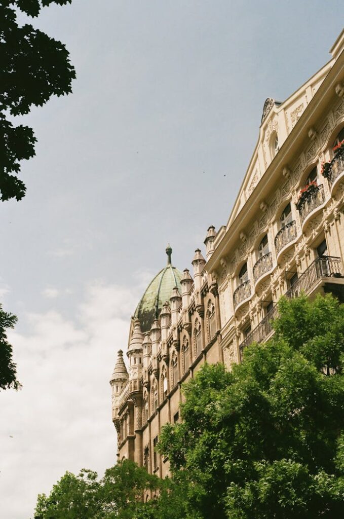 Historic building in Liberty Square, Budapest, showcasing classic architecture with lush greenery.